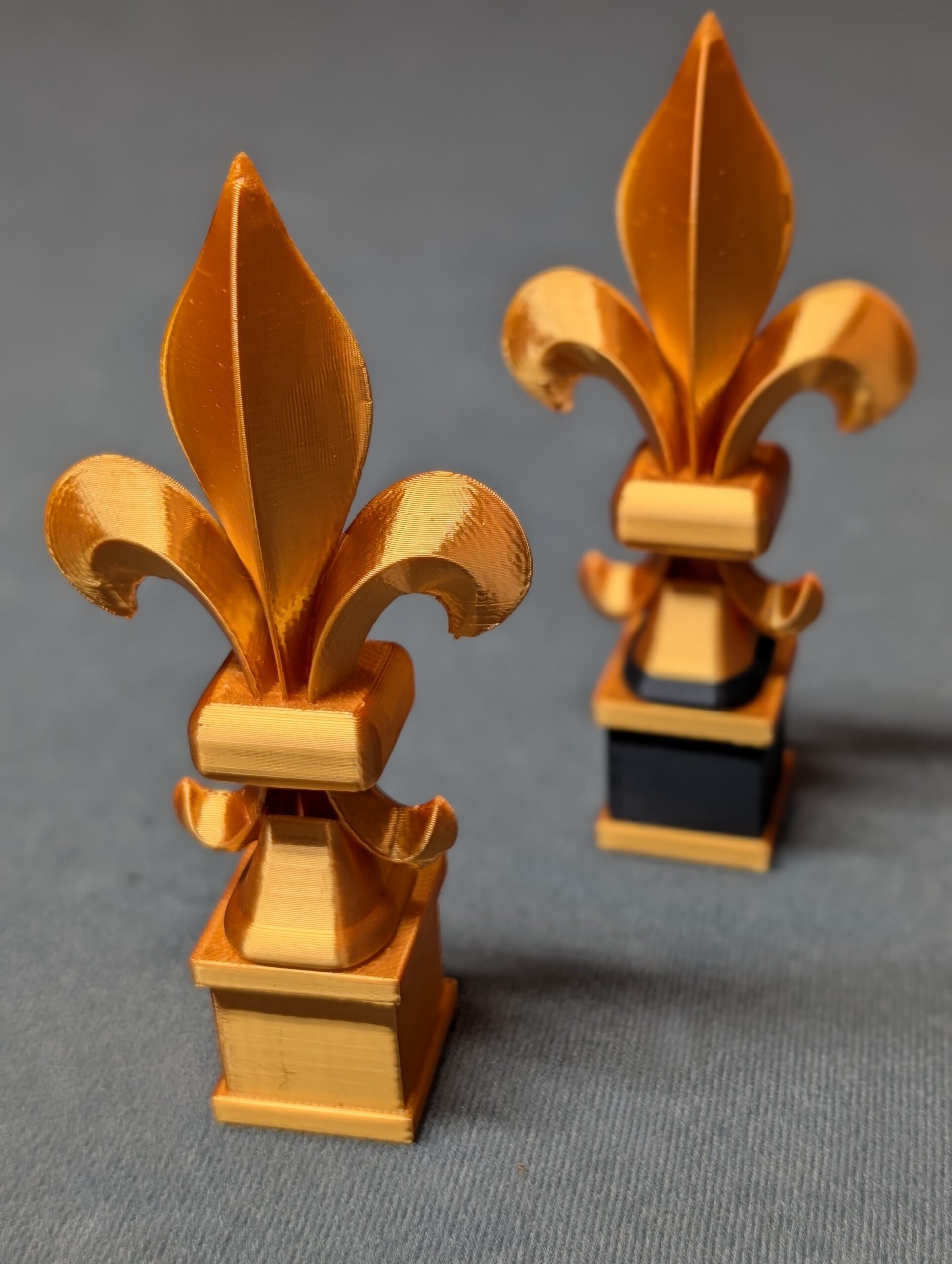 Two Fleur-Des-Lis versions on gray